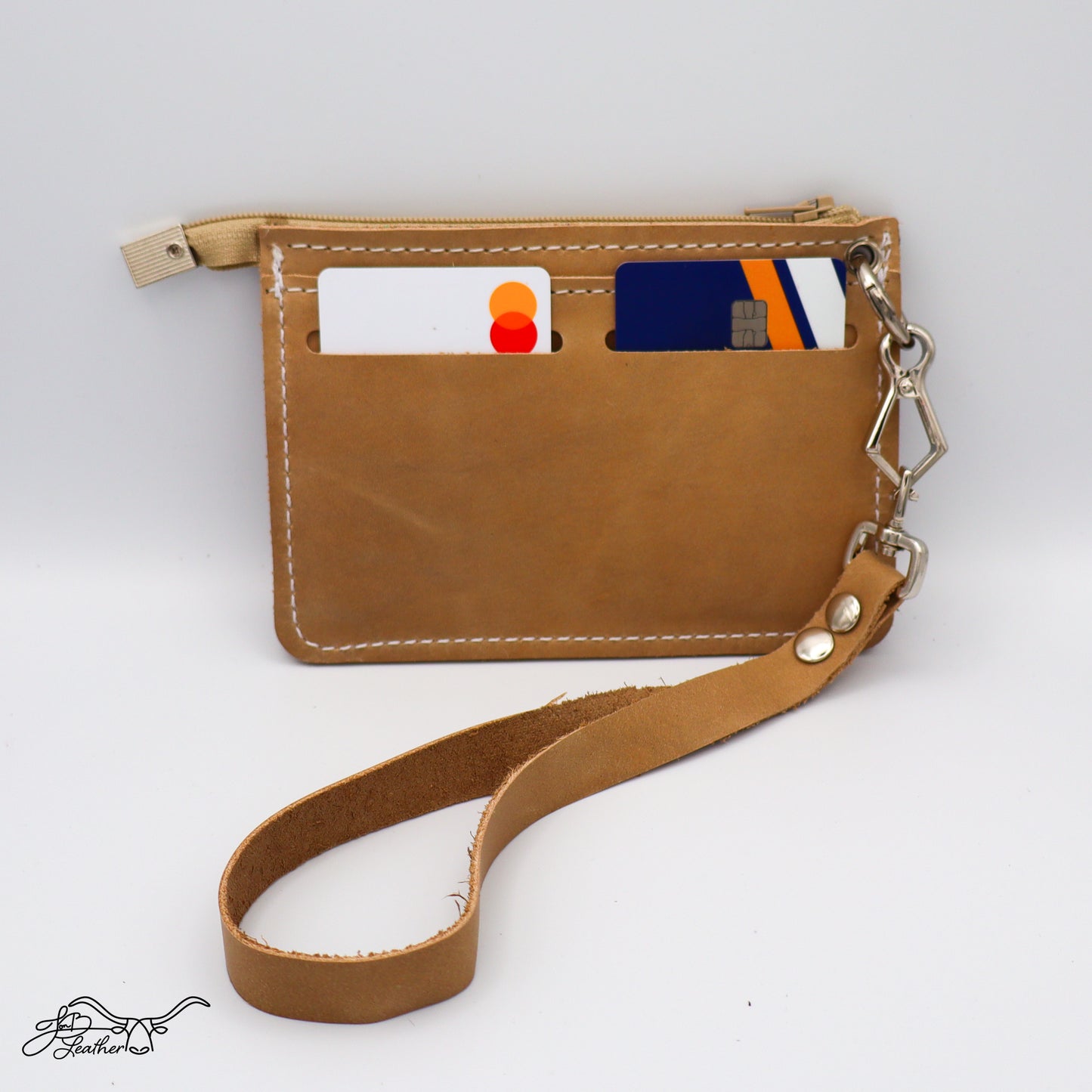 Handmade leather wristlet wallet showing exterior card slots