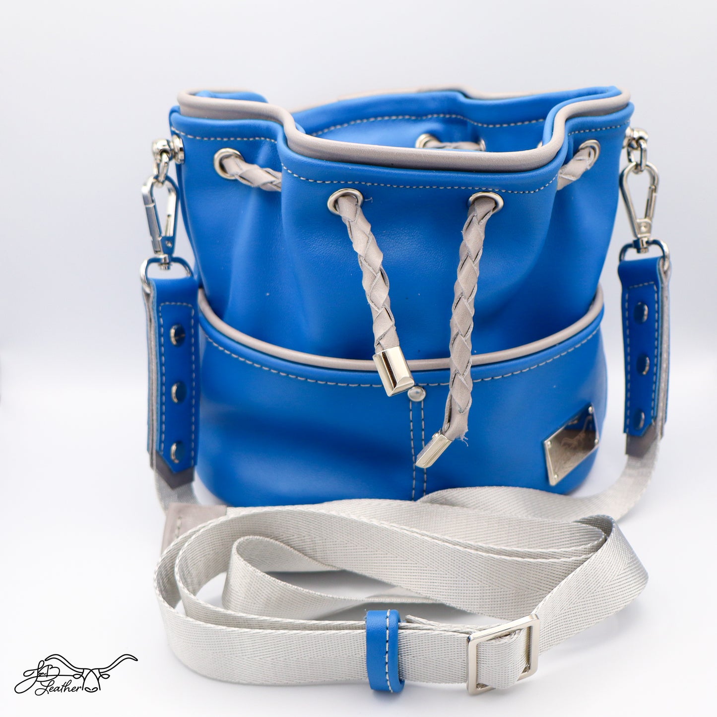 Mini Drawstring Crossbody in blue leather with gray piping