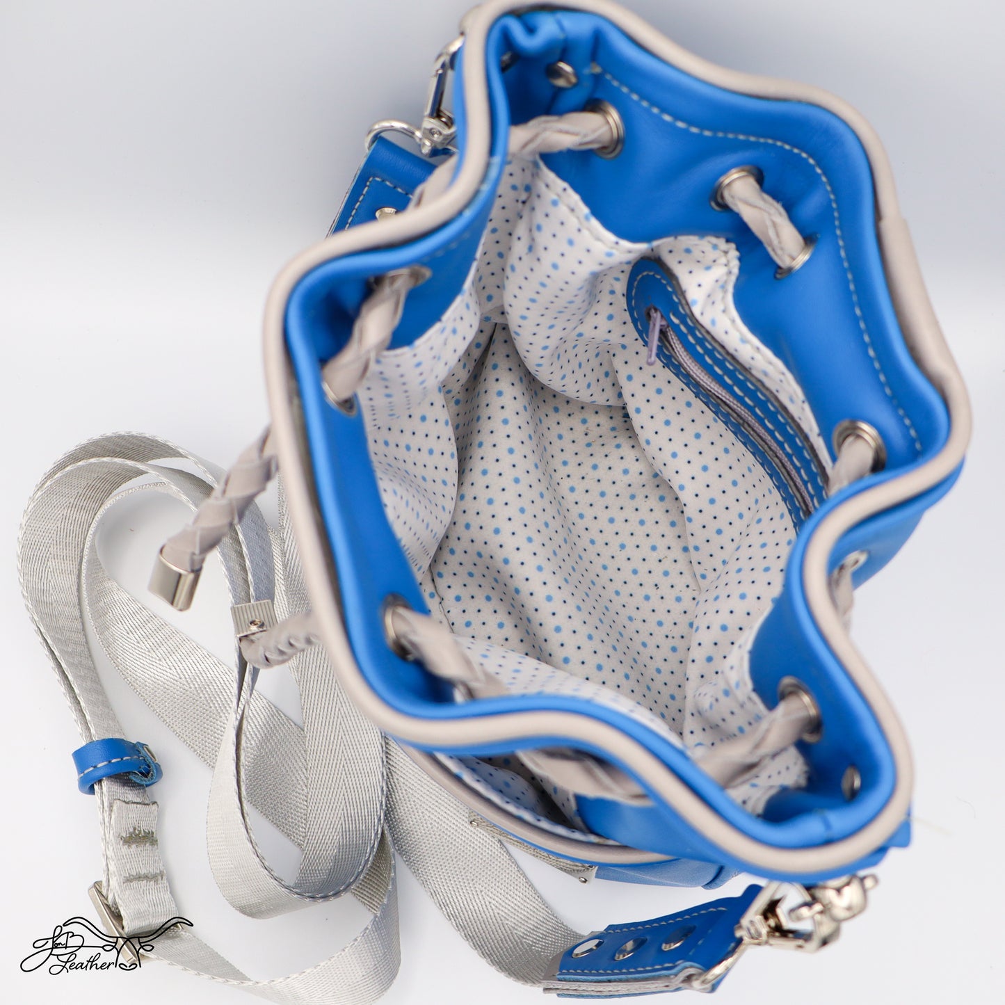 Open interior of Mini Drawstring Crossbody showing zipper pocket and lining