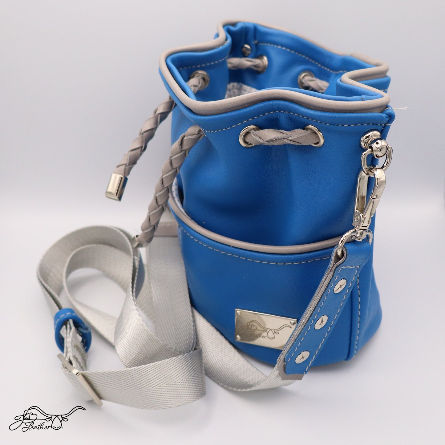 Side view of oval-shaped Mini Drawstring Crossbody with adjustable strap