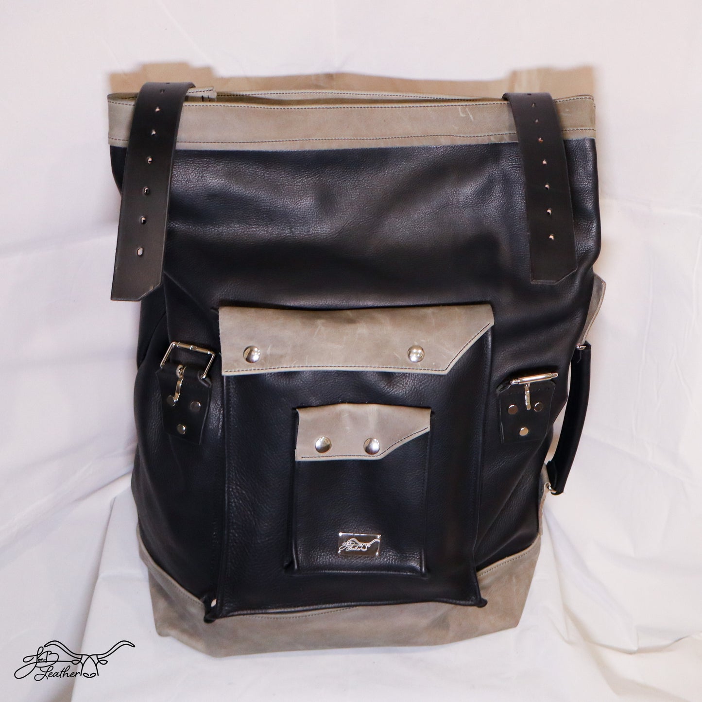 Roll Top Leather Backpack front view showing dual exterior pouches