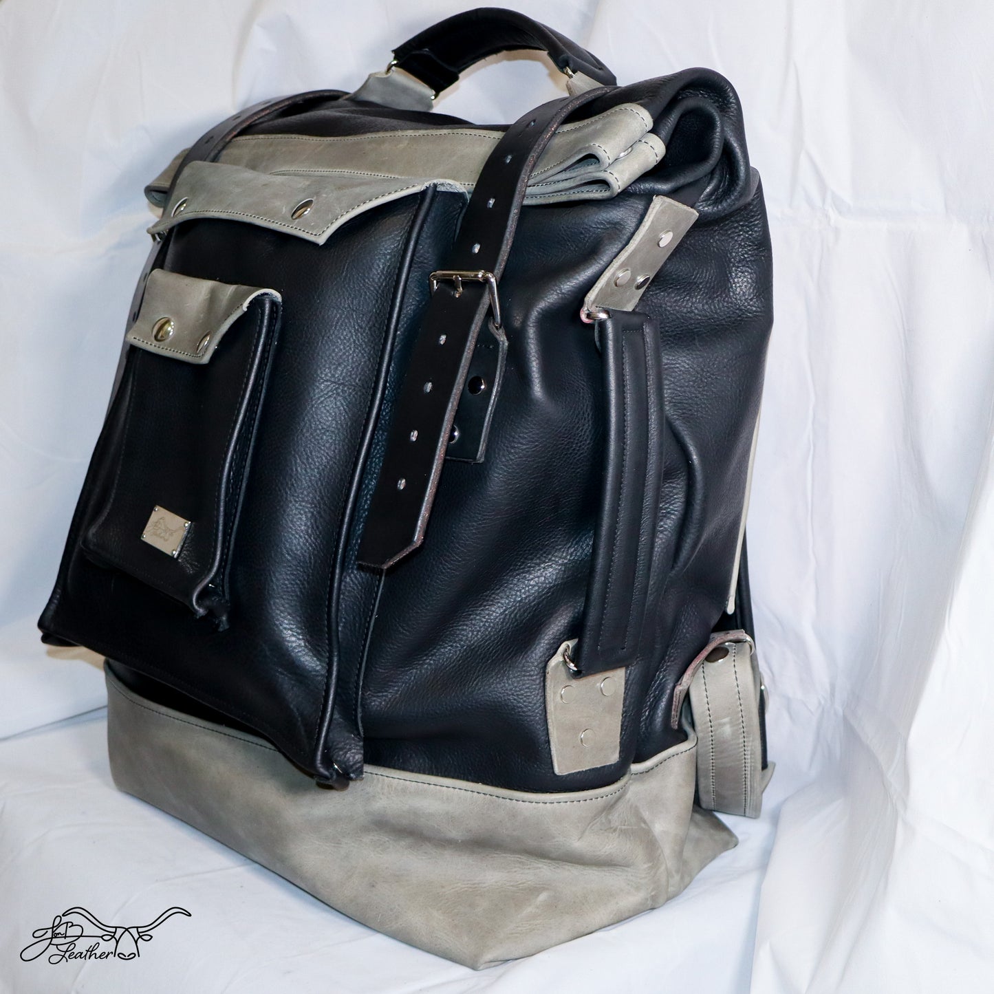 Roll Top Leather Backpack front view showing side view with side handle