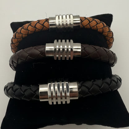 Three braided leather bracelets with silver clasp on a white background