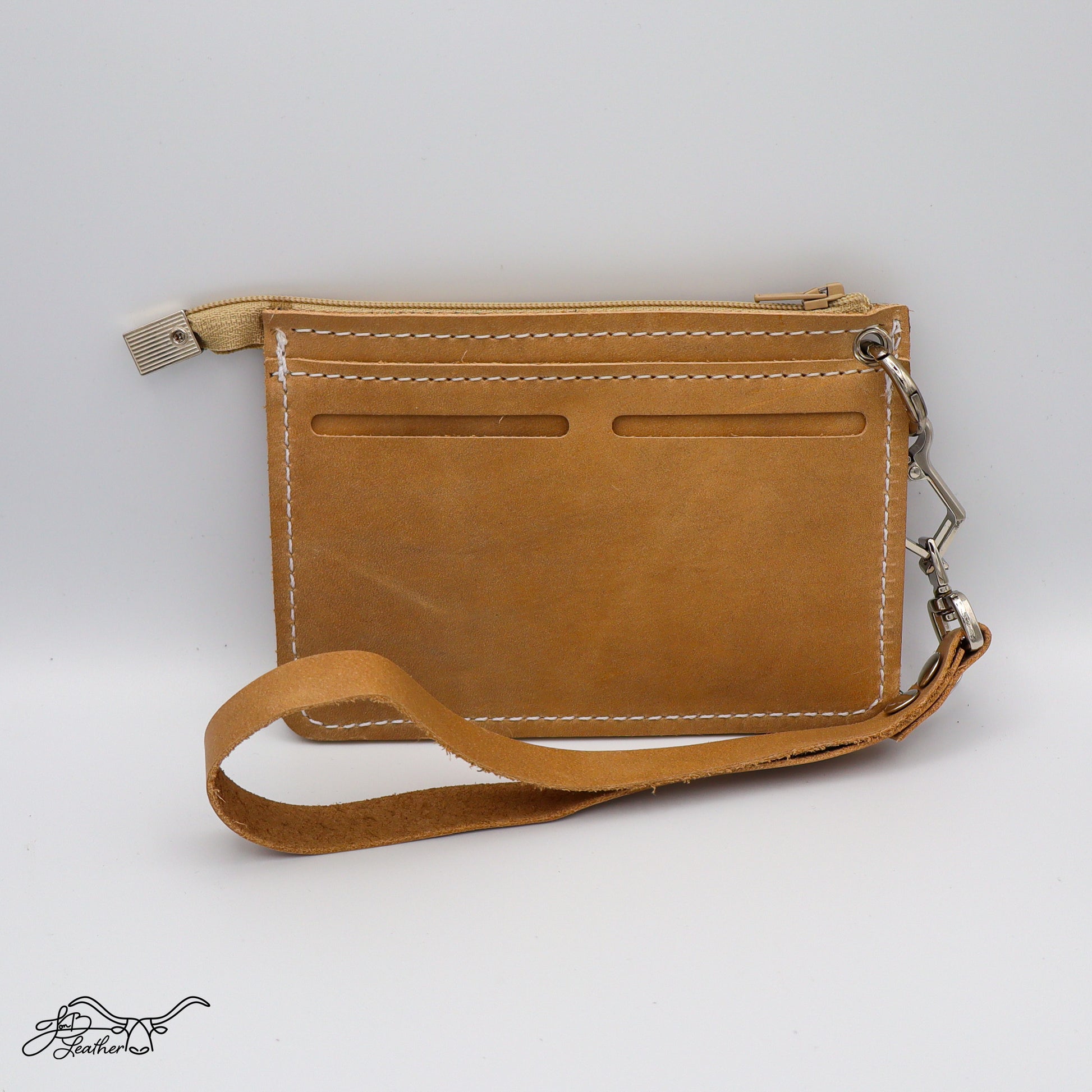 Handmade leather wristlet wallet showing exterior card slots
